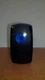 V2D1A60B (ON)OFF LIGHTED ROCKER SWITCH MOMENTARY (ON) CONTURA V BLUE LENS V2D1